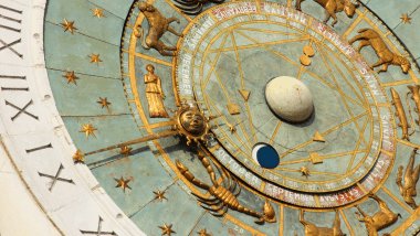 A imagem foca em algumas partes de um relógio astrológico.