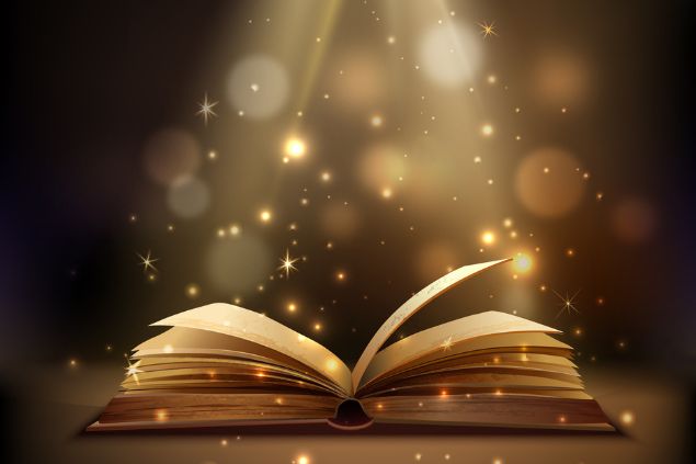 Imagem de um livro aberto recebendo uma luz que vem de cima e brilhos em volta
