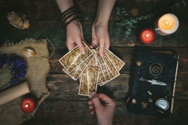 Imagem de uma consulente tirando as cartas com uma taróloga.