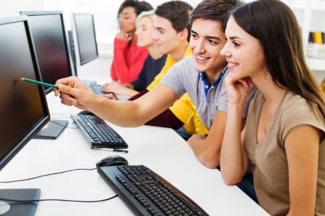 Imagens de estudantes do signo de touro em uma sala de aula cheia de computadores.