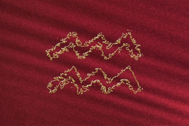 Imagem de fundo vermelho e em destaque o elemento do signo de Aquário no horóscopo