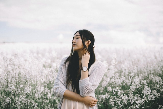 Mulher asiática num campo de flores.