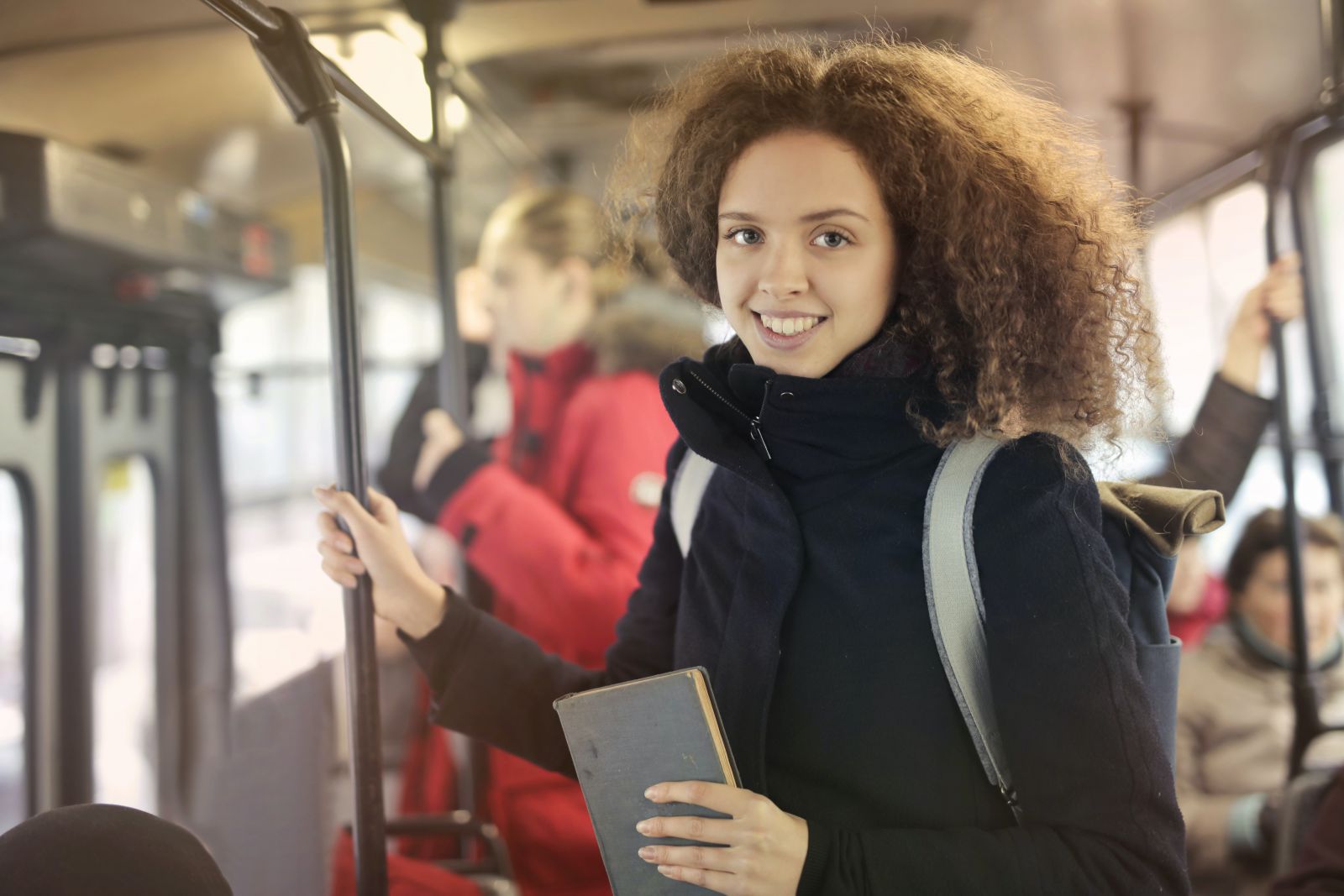 Mulher em pé dentro do ônibus 
