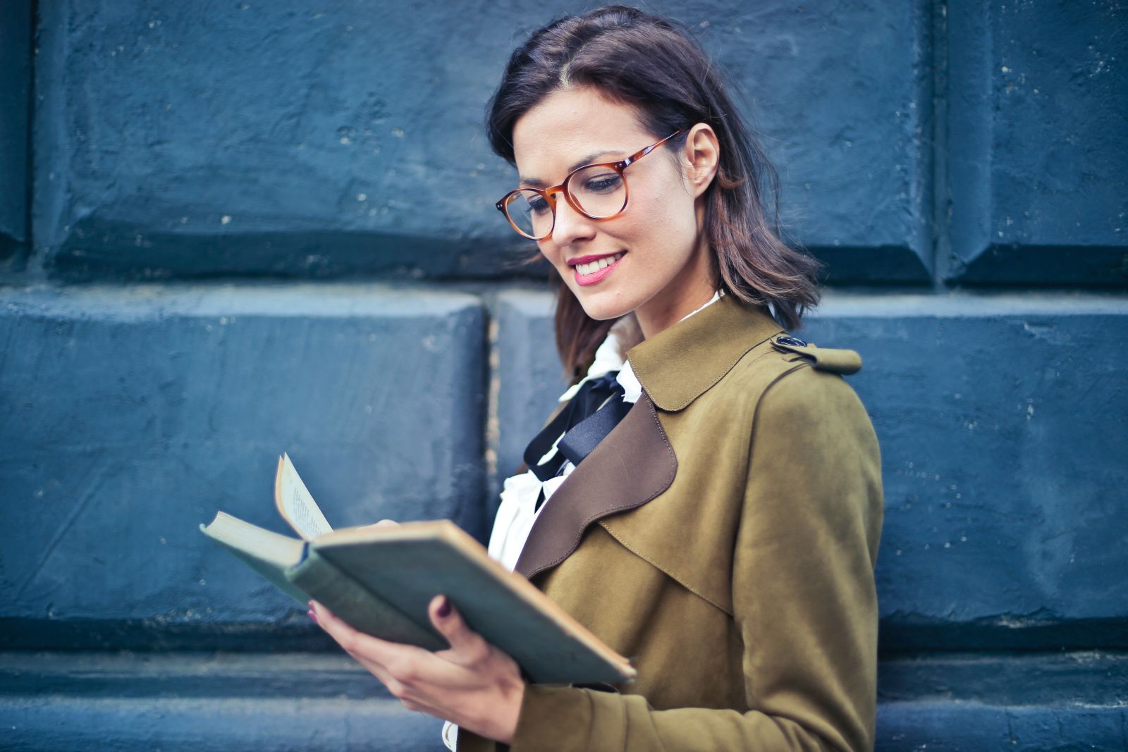 Mulher lendo um livro e sorrindo