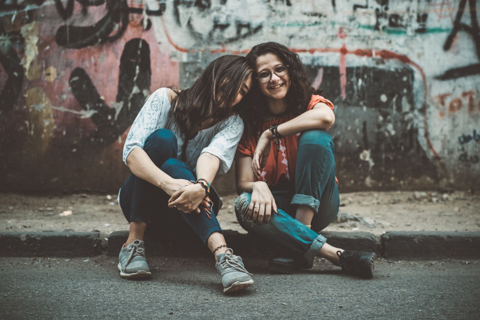 Duas mulheres sentadas em uma calçada